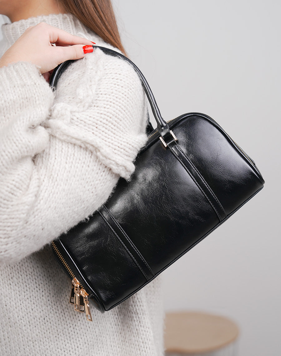 Sac noir brillant à double fermeture dorée