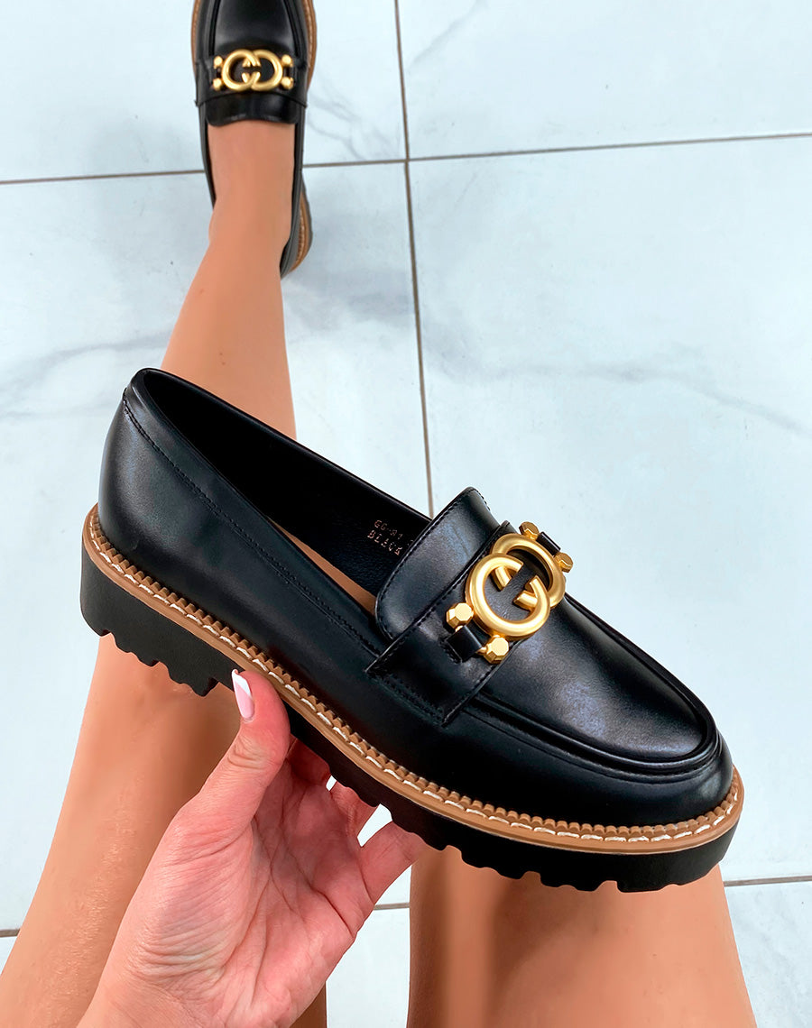 Mocassins noires à plateforme crantée avec détail doré
