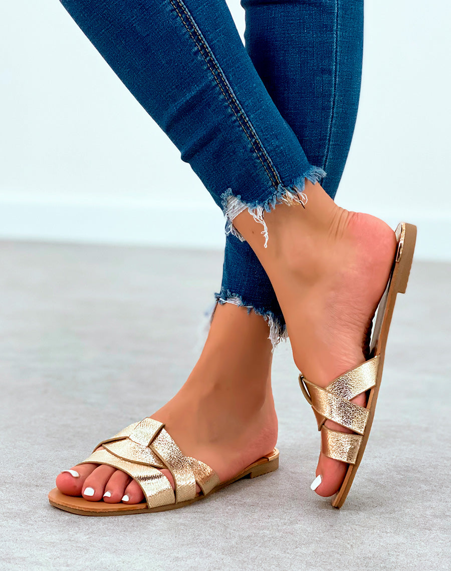 Mules dorées plates à bride entrecroisées et à détail dorée et noir