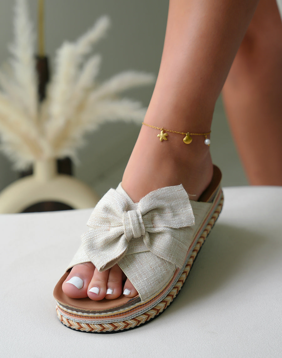 Mules femmes beiges avec n?ud et d?tails azt?ques sur plateforme ?paisse