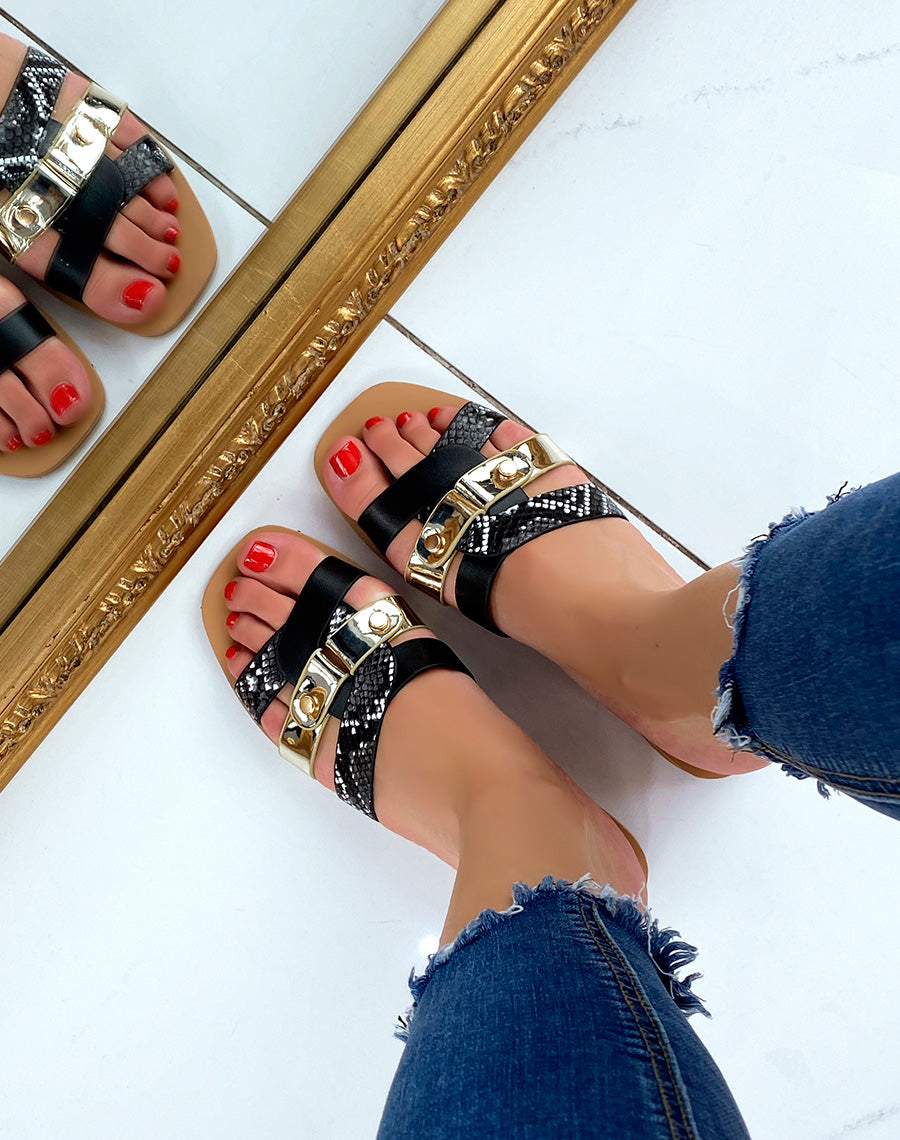 Mules plates noires à brides entremêlées et détails python et dorés