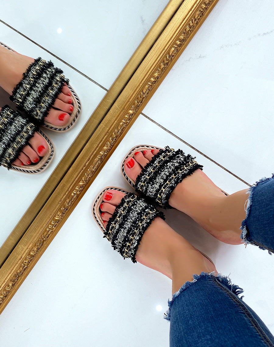 Mules plates noires à multiples détails et fine chaîne dorée