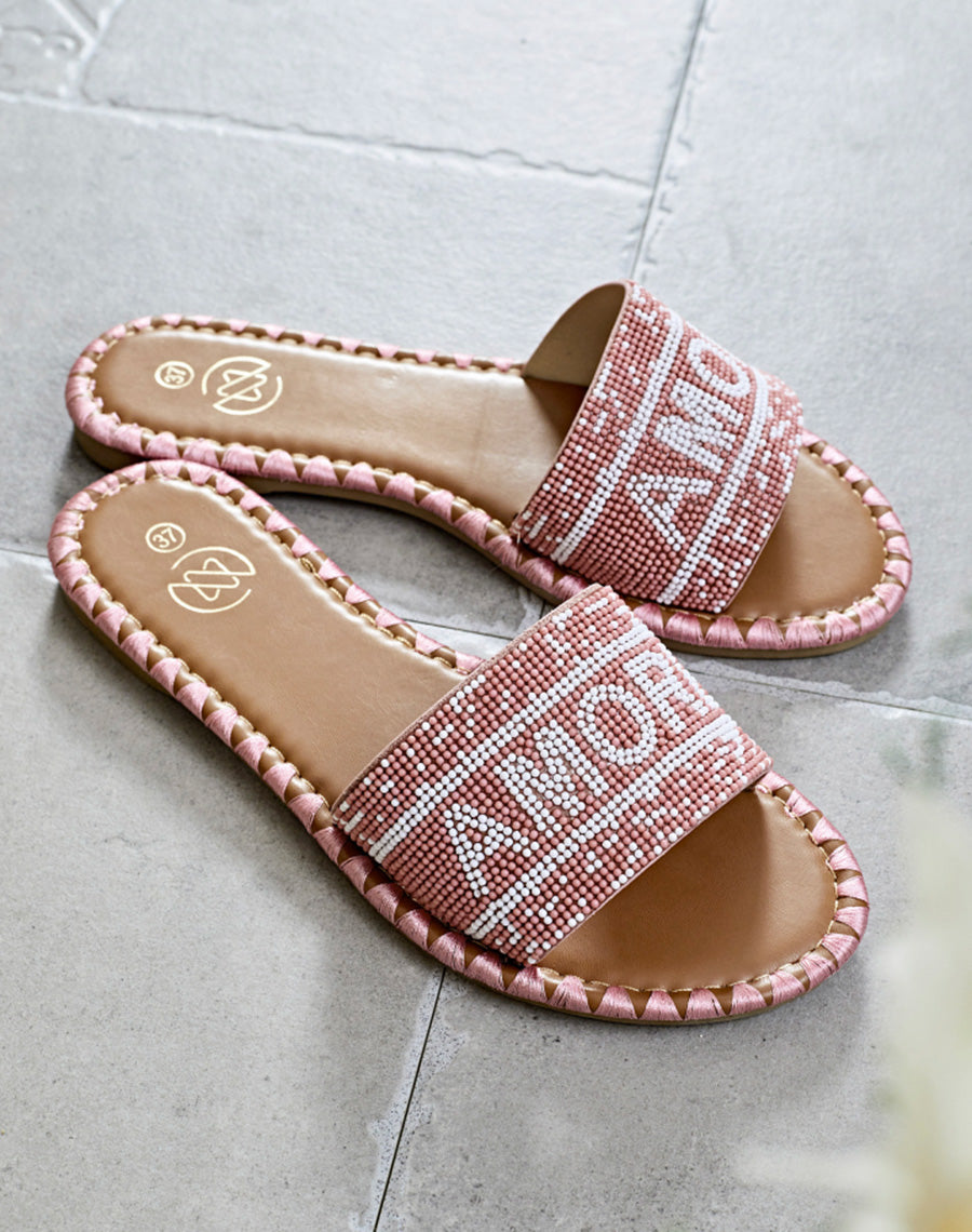 Mules roses à bride avant à inscription perlée