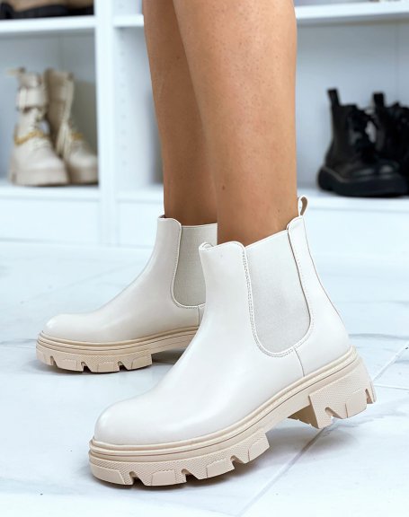Beige heeled chelsea boots with notched sole