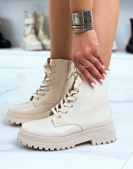 Beige lace-up ankle boots with a notched flat sole