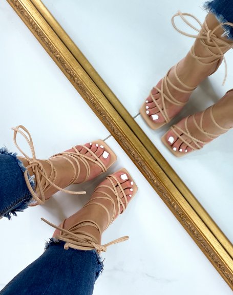 Beige sandals with criss-cross laces and high square heel
