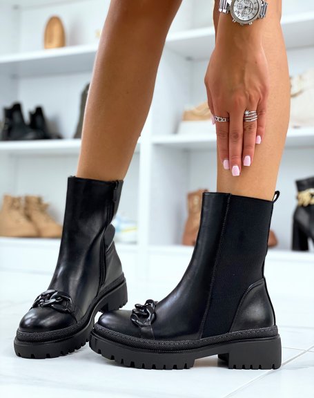 Black ankle boots adorned with a black chain