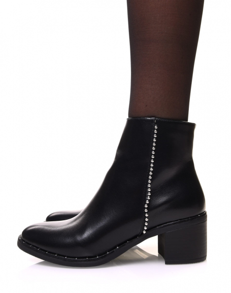 Black ankle boots with beaded stitching on the side