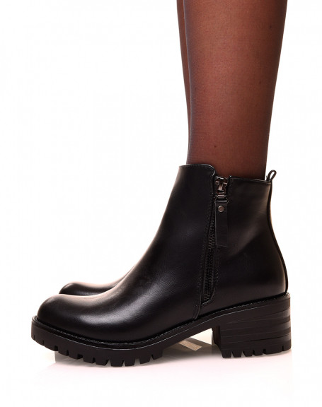 Black ankle boots with decorative closure and lug sole