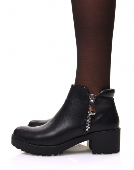 Black ankle boots with decorative zipper and mid-high heel