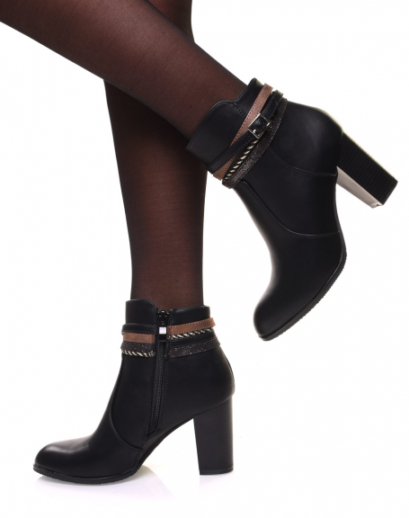 Black ankle boots with high heels and decorative straps