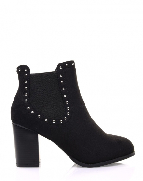 Black Chelsea boots adorned with studs and heels
