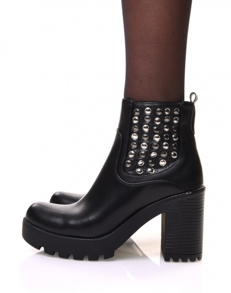 Black Chelsea boots with heels and studded details on the side of the foot