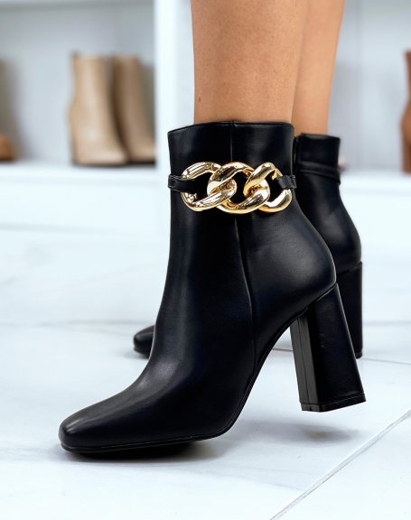 Black heeled ankle boots with square toe and gold chain