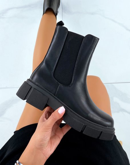 Black high top Chelsea boots with notched sole