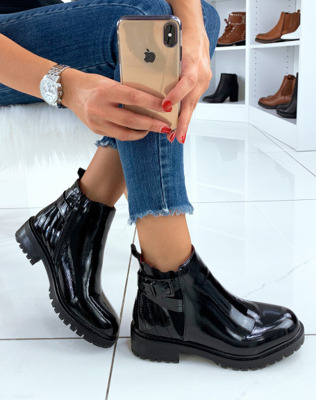 Black patent ankle boots with straps and red interior