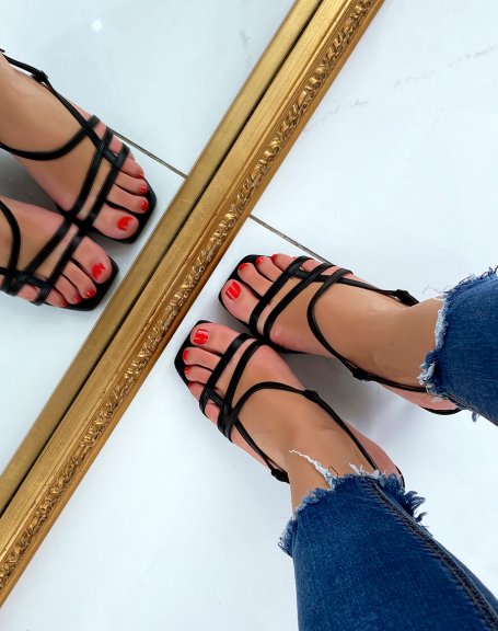 Black sandals with a small thin heel and crossed straps