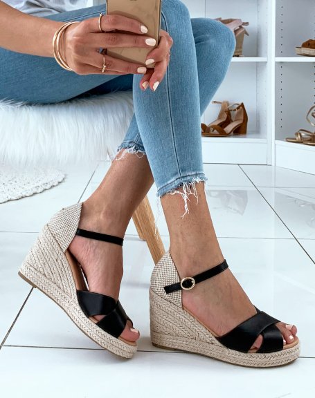 Black sandals with wedge heels and crossed straps