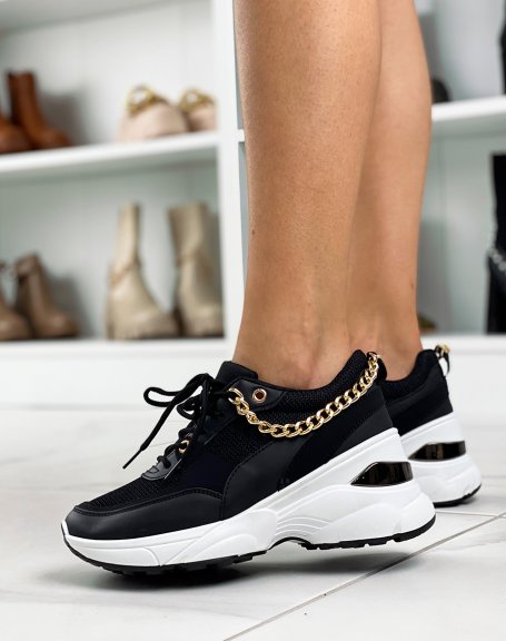Black sneakers with white sole and gold chain