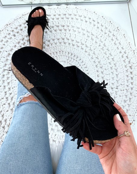 Black suede mules with wide knotted straps and fringes