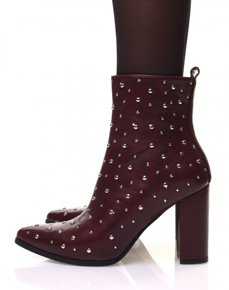 Burgundy high-heeled ankle boots adorned with round studs