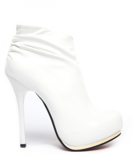 Jennika white ankle boot with red sole and gold zip
