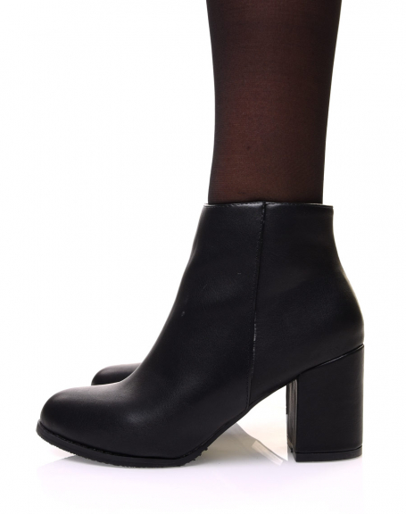 Minimalist black ankle boots with mid high heels