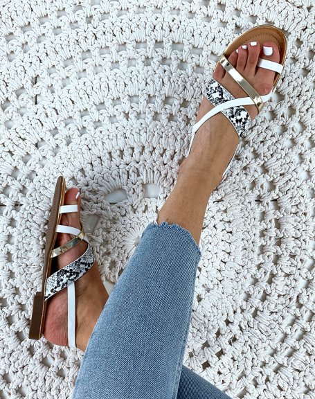 Sandals with multiple crisscrossed white gold straps and python effect