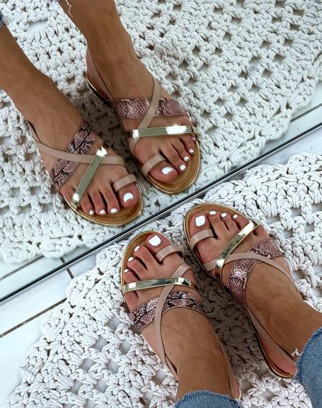Sandals with multiple crisscrossing golden pink straps and python effect