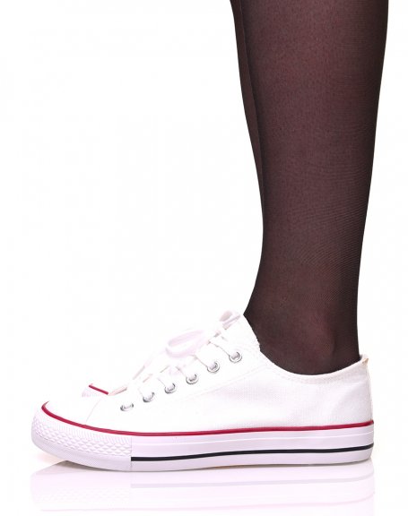 White canvas sneakers with white laces and red piping