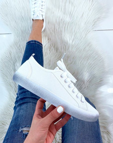 White fabric sneaker with faded blue sole