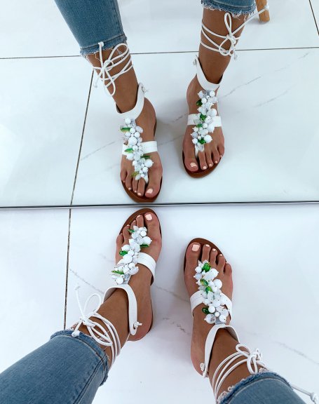 White sandals adorned with white and green pearls