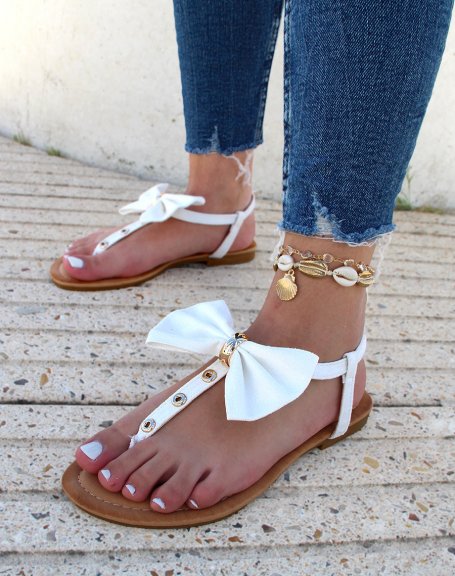 White sandals with bow and gold details
