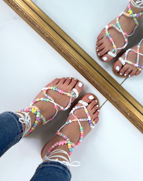 White sandals with long straps with colored beads