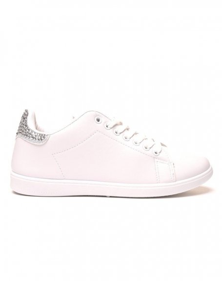 White sneakers with silver rhinestone details on the back