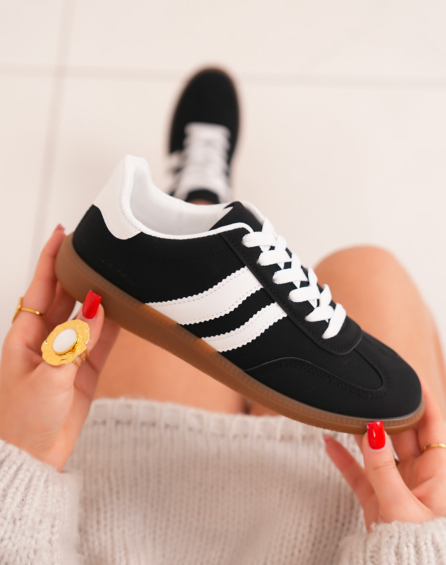 Trendy black woman sneakers with white scratches and brown sole