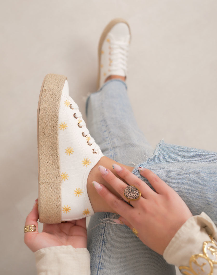 Basket femme blanche tendance en toile avec soleils dorés et semelle plateforme en osier