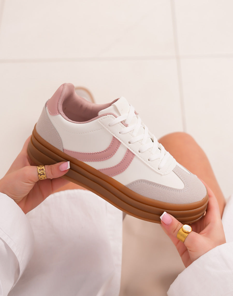 White female sneakers with pink stripes and triple brown platform