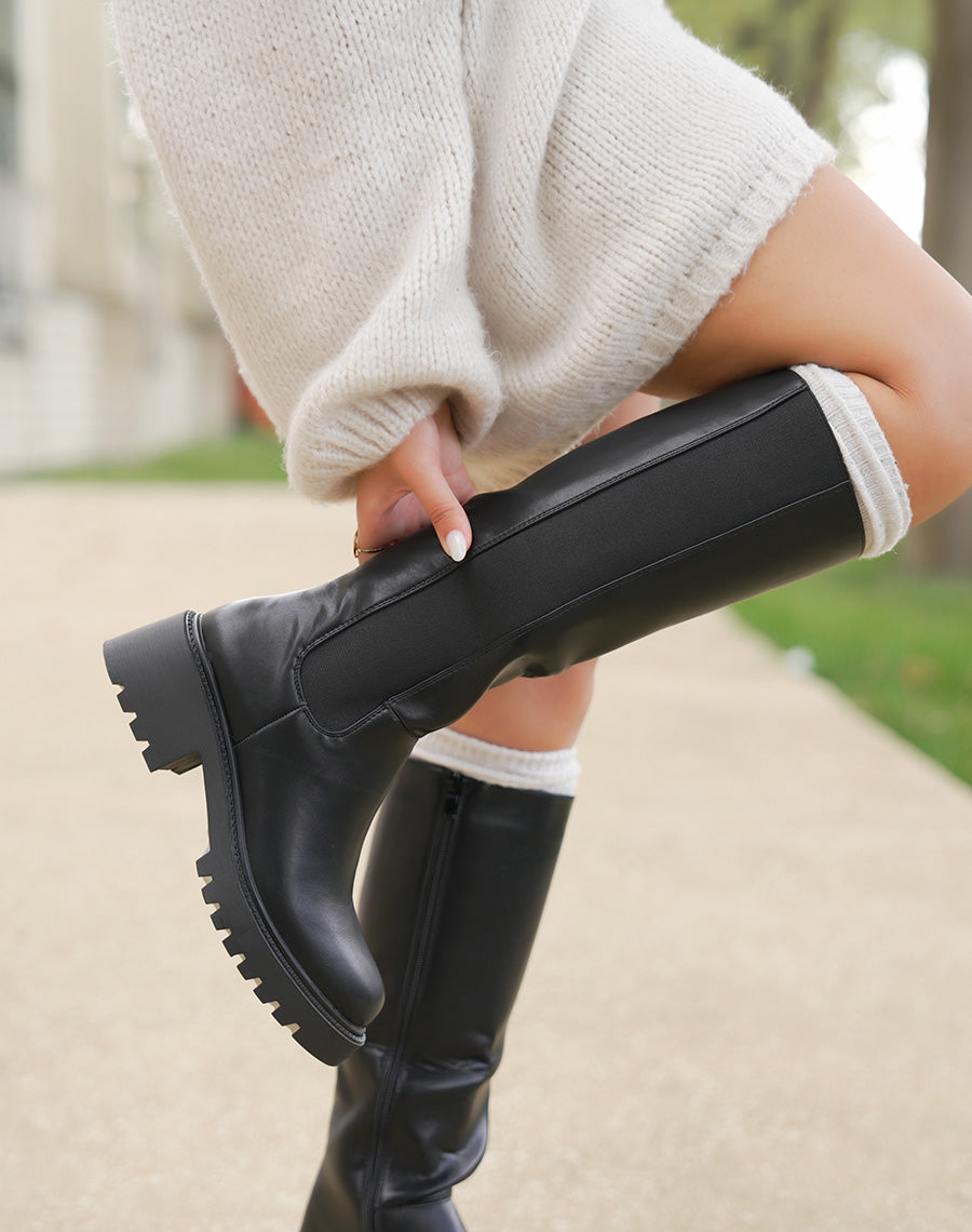 Bottes noires à semelle crantée et élastique latéral