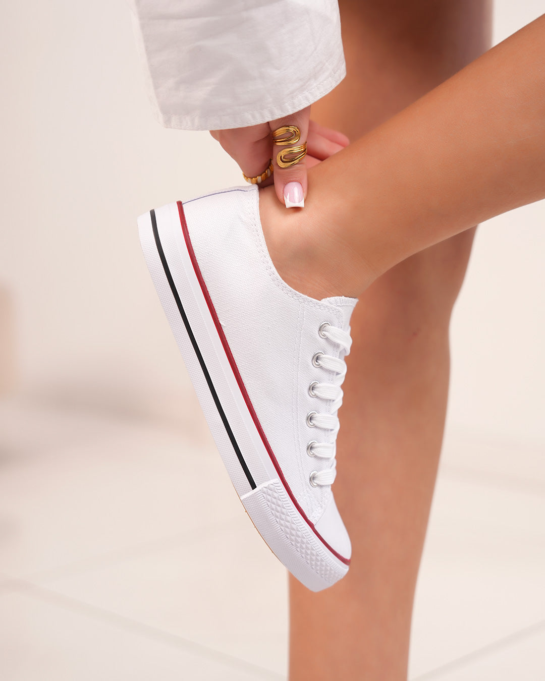 White sneakers with red border