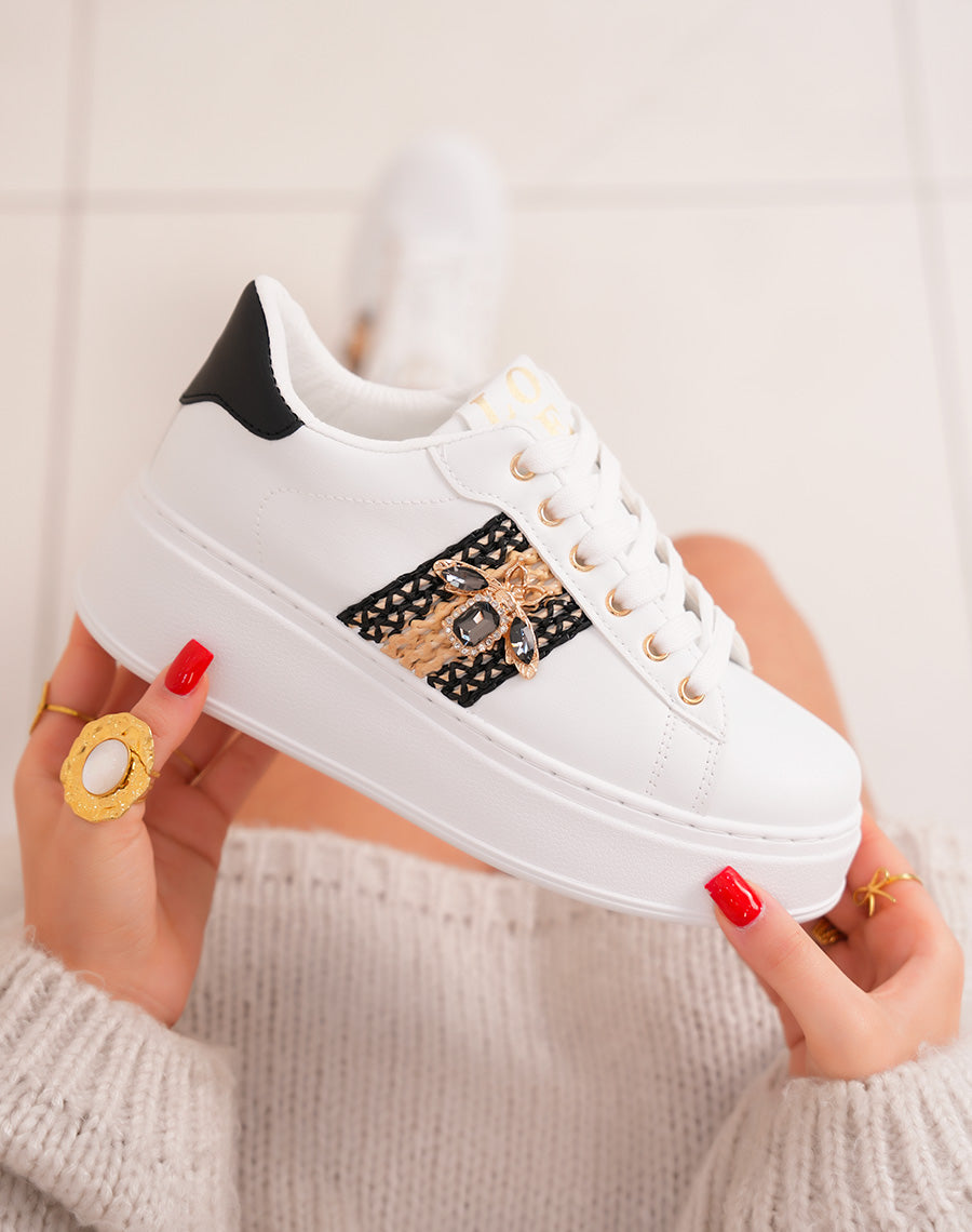 Elegant white women's sneakers with woven detail and golden jewelry