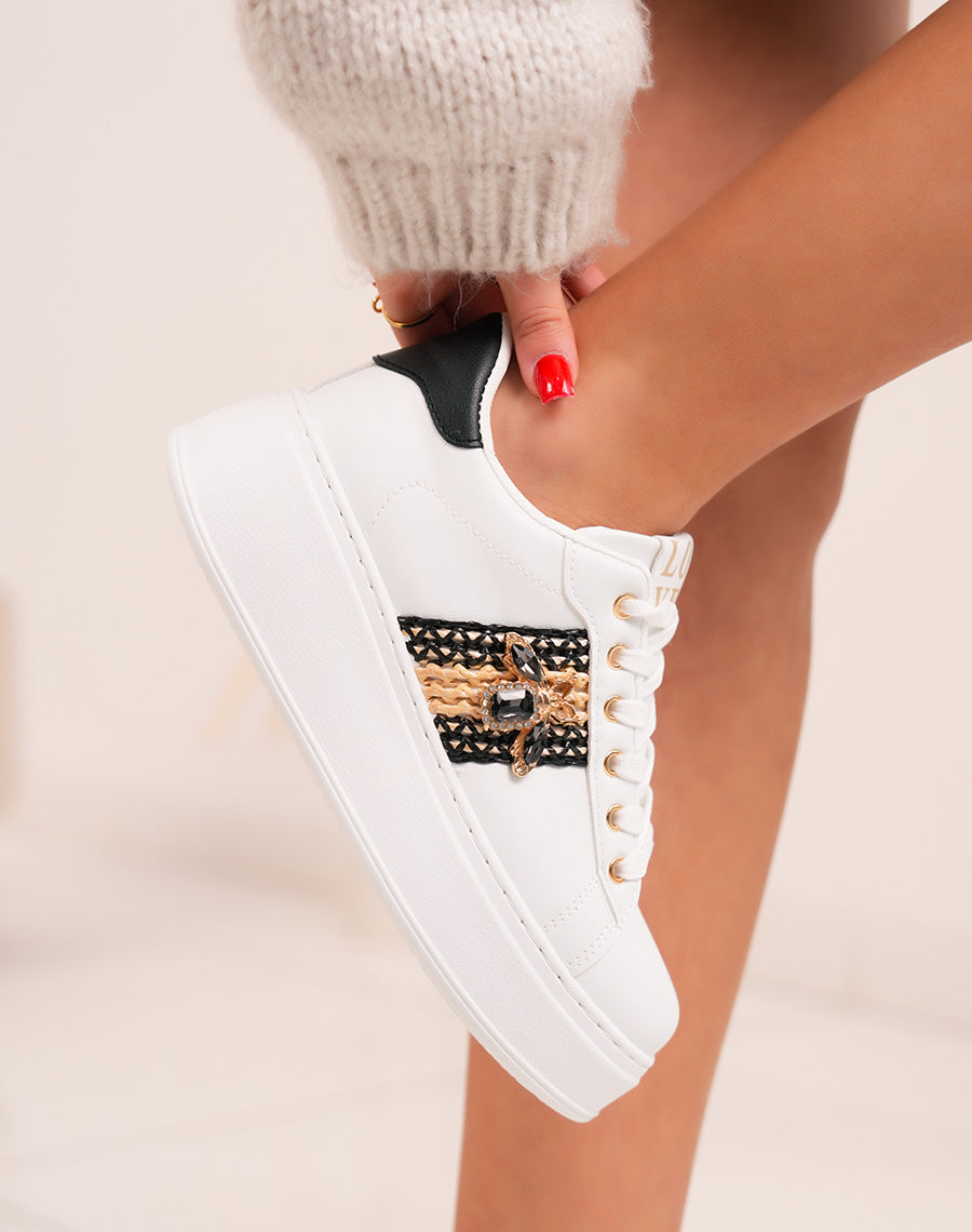 Elegant white women's sneakers with woven detail and golden jewelry
