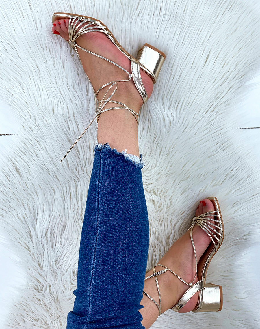 Sandales dorées à petit talon et longues lanières